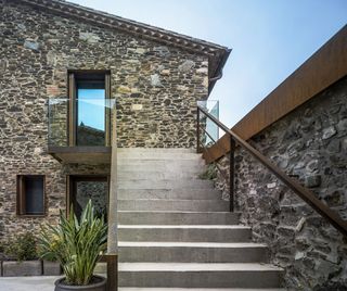 modern clean cut glass juxtaposing the property's rustic stone walls