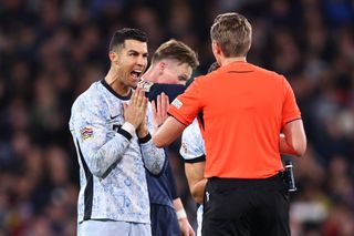 GLASGOW, SCOTLAND - OCTOBER 15: Cristiano Ronaldo of Portugal reacts towards Referee Lawrence Visser of Belgium during the UEFA Nations League 2024/25 League A Group A1 match between Scotland and Portugal at on October 15, 2024 in Glasgow, Scotland. (Photo by Robbie Jay Barratt - AMA/Getty Images)