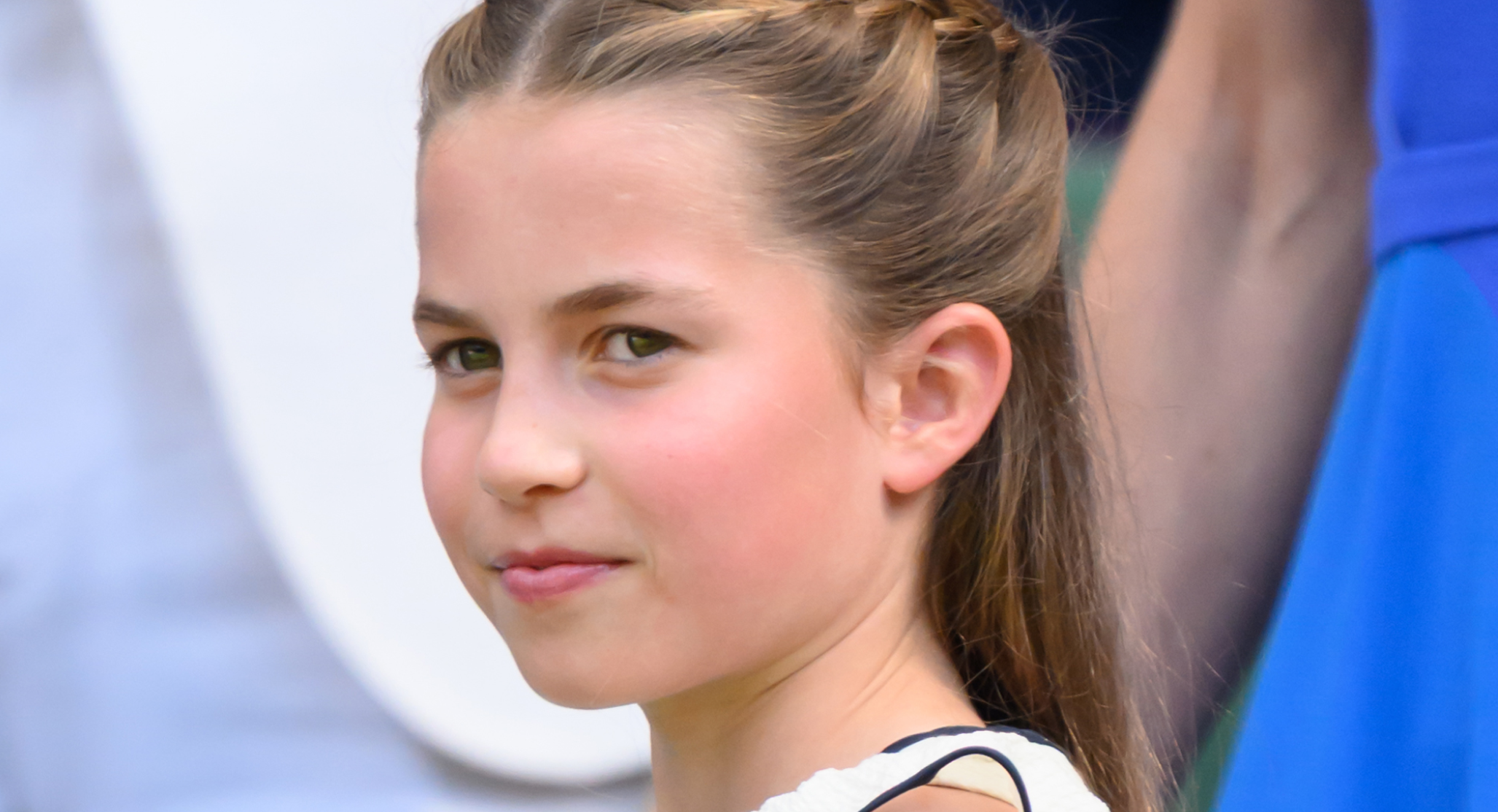 Princess Charlotte has braided hair and wears a white dress