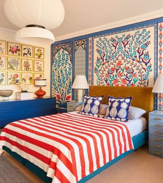 bedroom with striped bedding and painted patterned walls