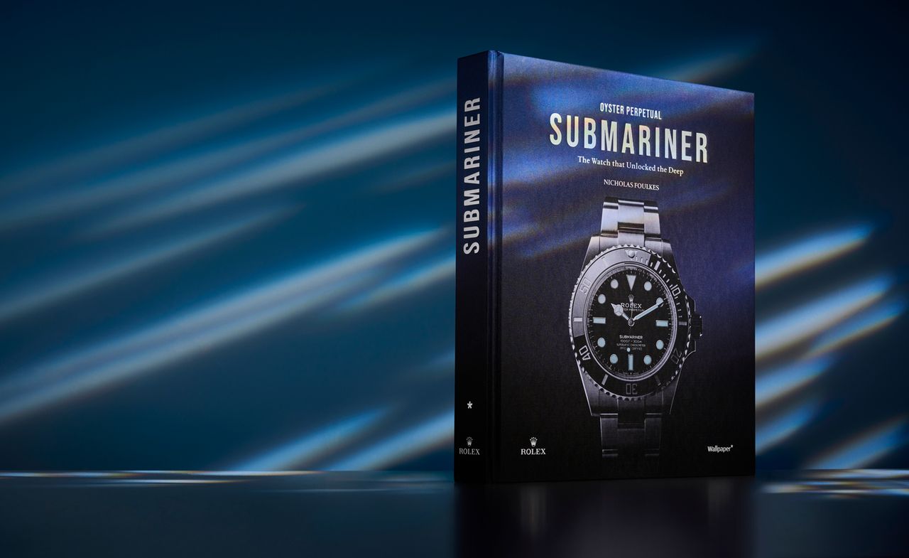 Rolex &#039;Oyster Perpetual Submariner – The Watch that Unlocked the Deep&#039; book on blue background