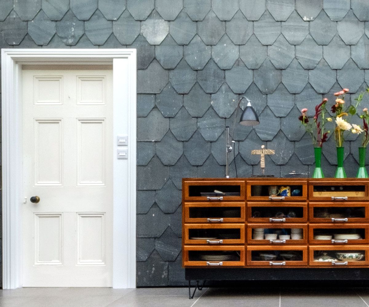 Slate fish-scale type tiles on the wall of a side extension