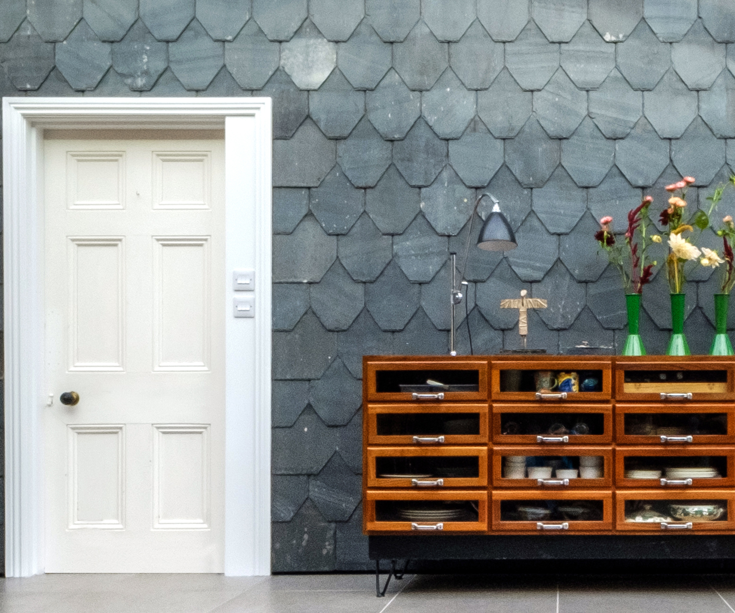 Slate fish-scale type tiles on the wall of a side extension