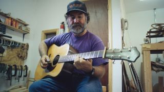 American luthier Wayne Henderson playing a guitar in his workshop, Rugby, Virginia, 20th June 1998. Henderson is a guitarist and specialist maker of custom acoustic guitars.