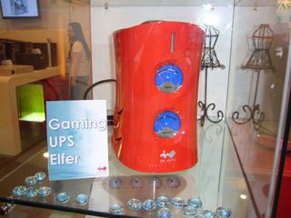 A brick-like UPS from In Win with voltage and temperature meters on the front.