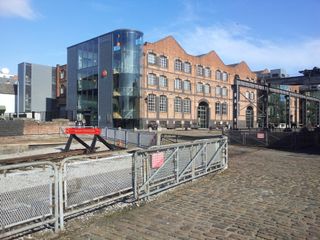 A view of the end of the old railways that linked Manchester mills with Liverpool. The Museum of Science and Industry (MOSI) is the building on the background.