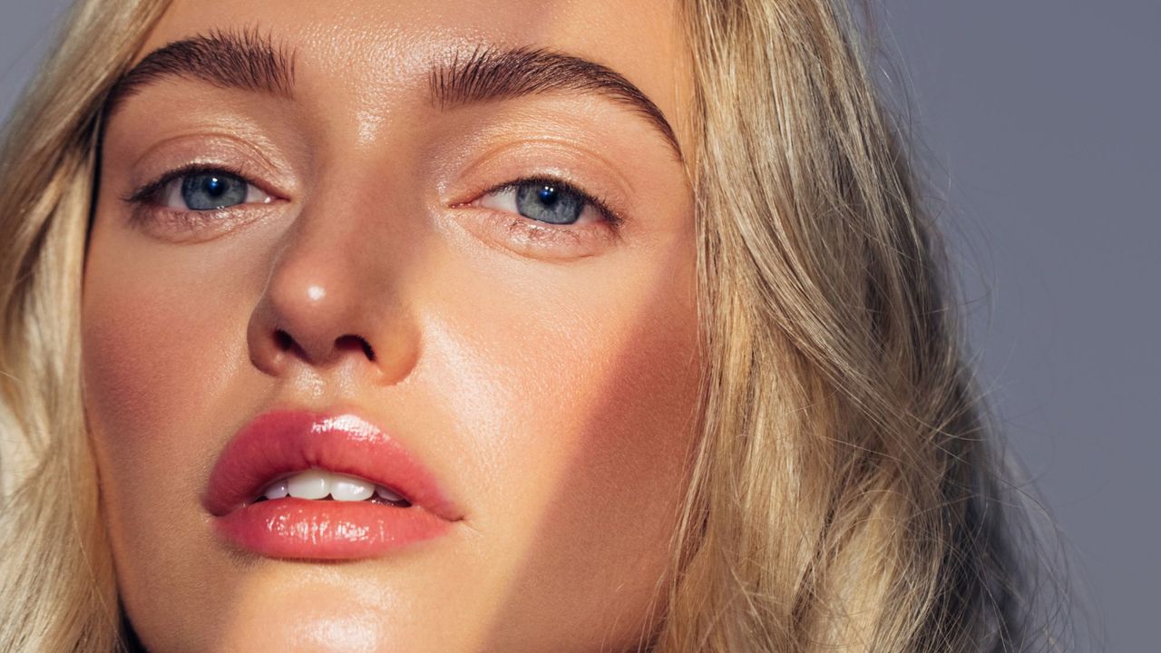 summer makeup looks - beautiful woman shot with sunlight on her face getty 1944687241