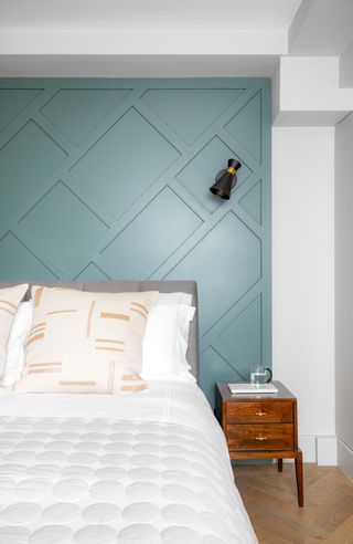 bedroom with large blue built in headboard