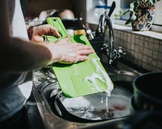 Man washing dishes at a sink