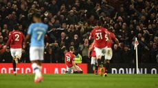 Man United fans and players celebrate Scott McTominay's goal against Man City