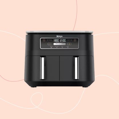 Cut out of a black Ninja air fryer on a pink background