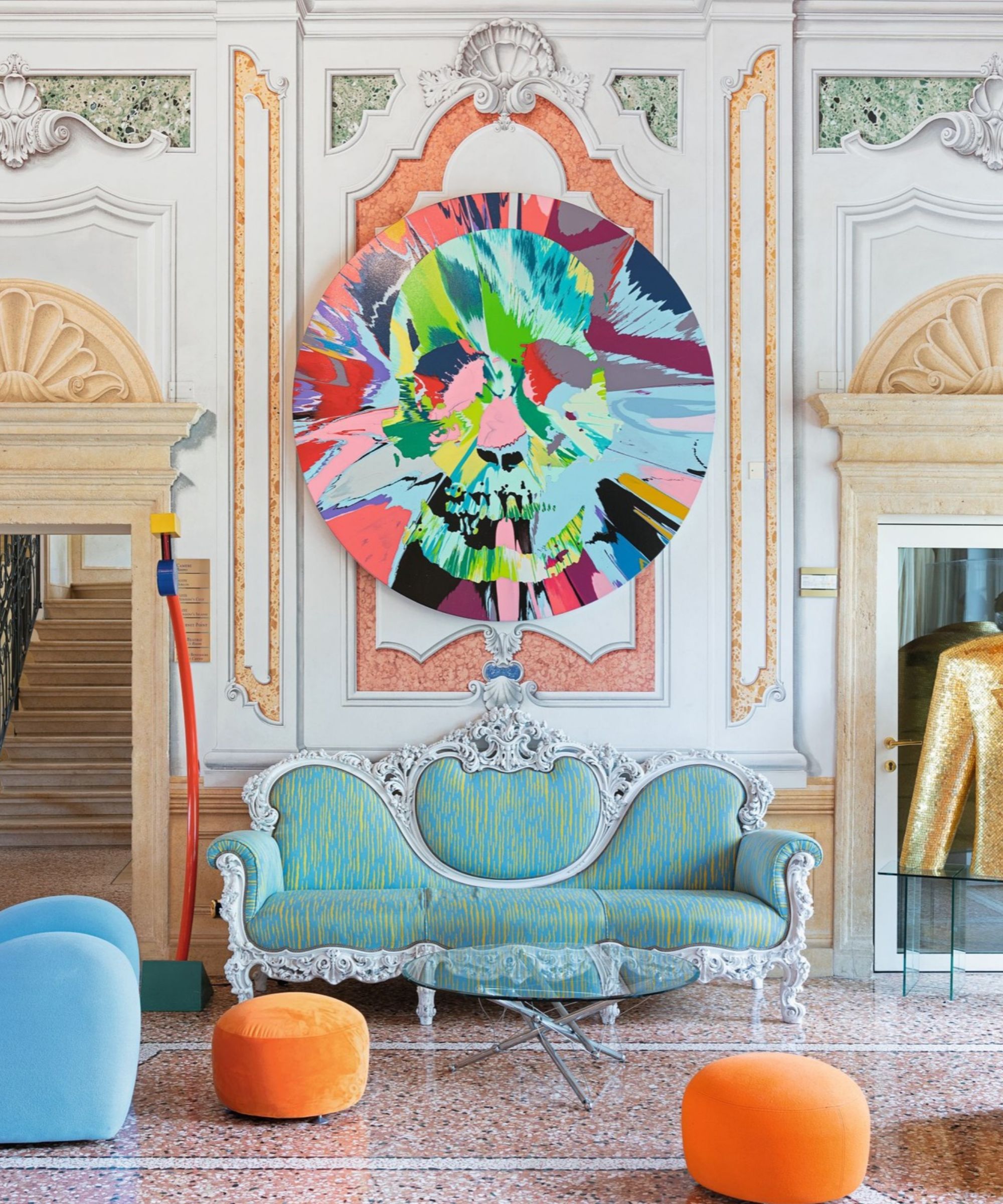 art hotel byblos seating area with sofa and circular painting above
