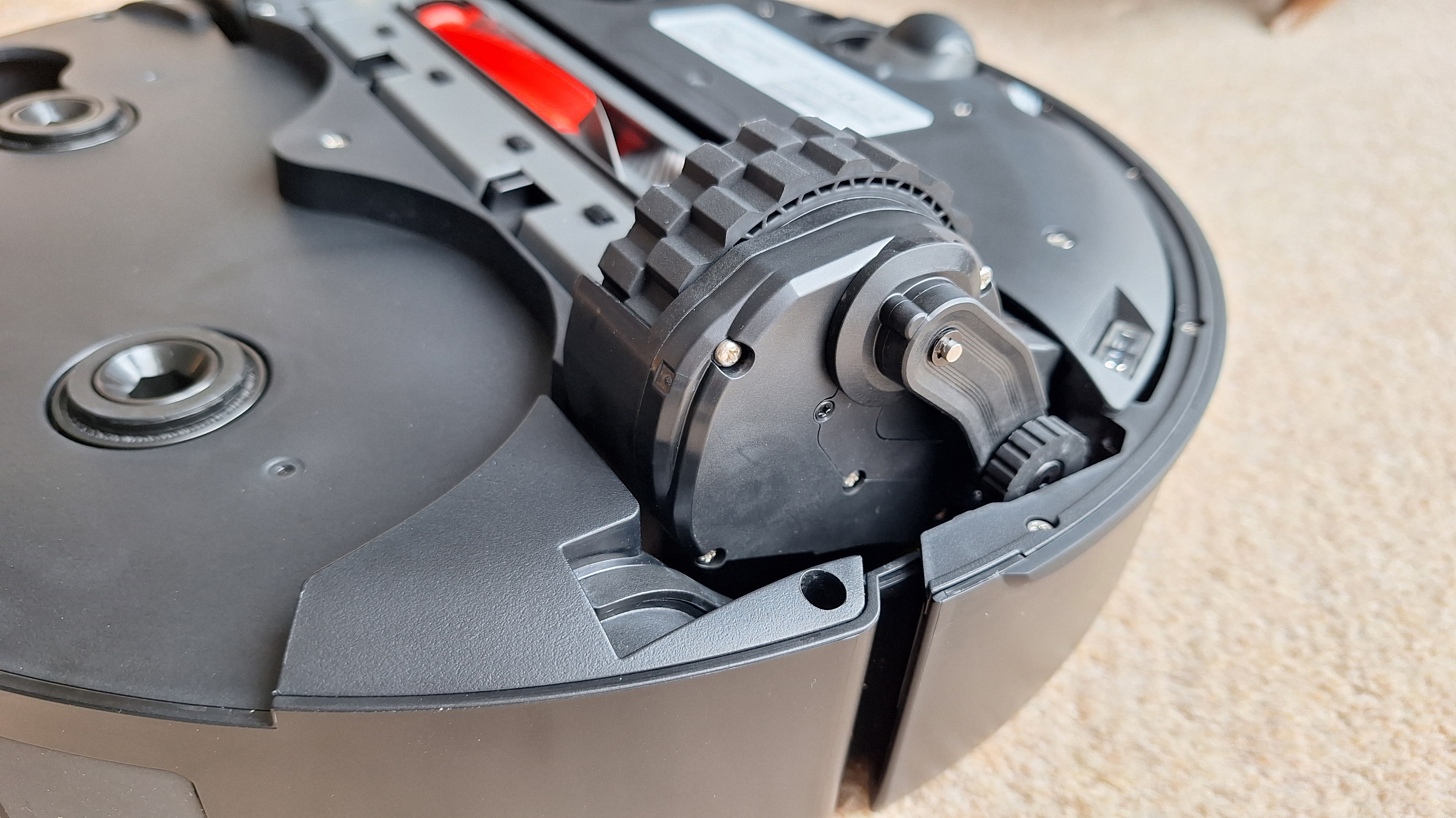 Roborock Saros 20 robot vacuum flipped over to show AdaptiLift wheels