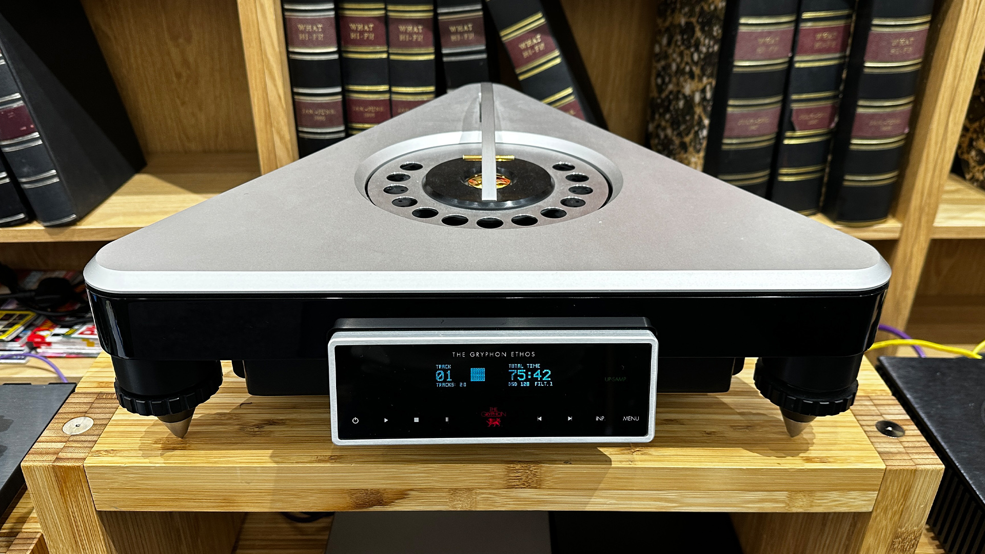 Gryphon Audio Ethos CD player on wooden hi-fi rack in front of bookcase