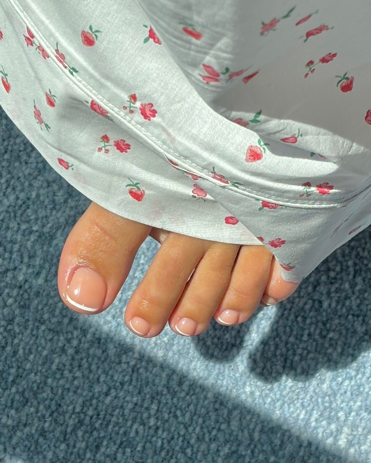 A peachy pedicure with a white French tip