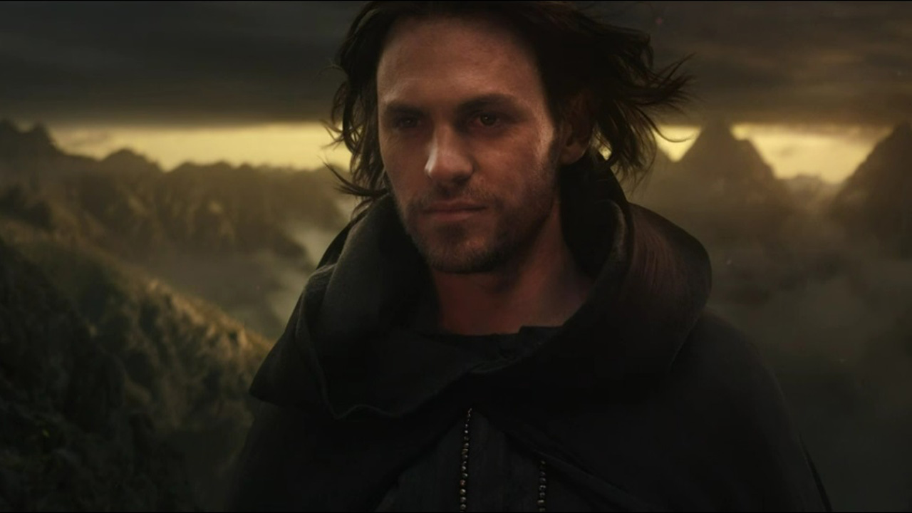 Halbrand, now known as Sauron, smiles as he glances at Mordor and Mount Doom in The Rings of Power 8.
