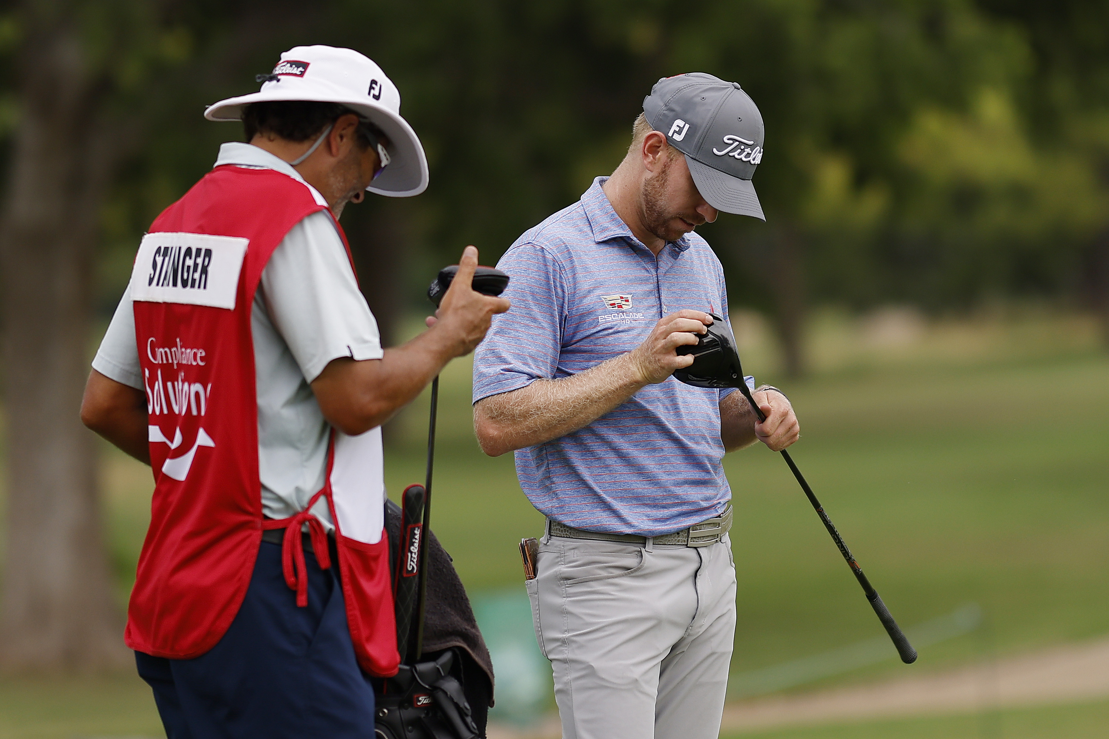 A golfer takes a look at his driver