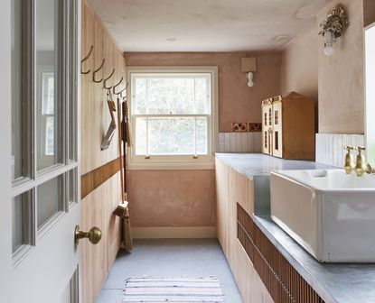 narrow utility room ideas with plaster walls and galley cupboards