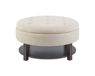 A padded storage ottoman coffee table in cream