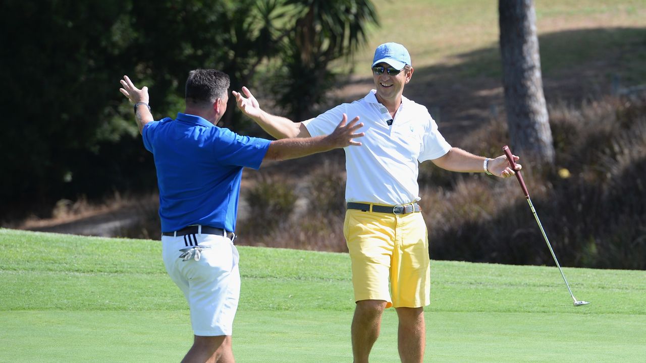 Golfers hug in celebration