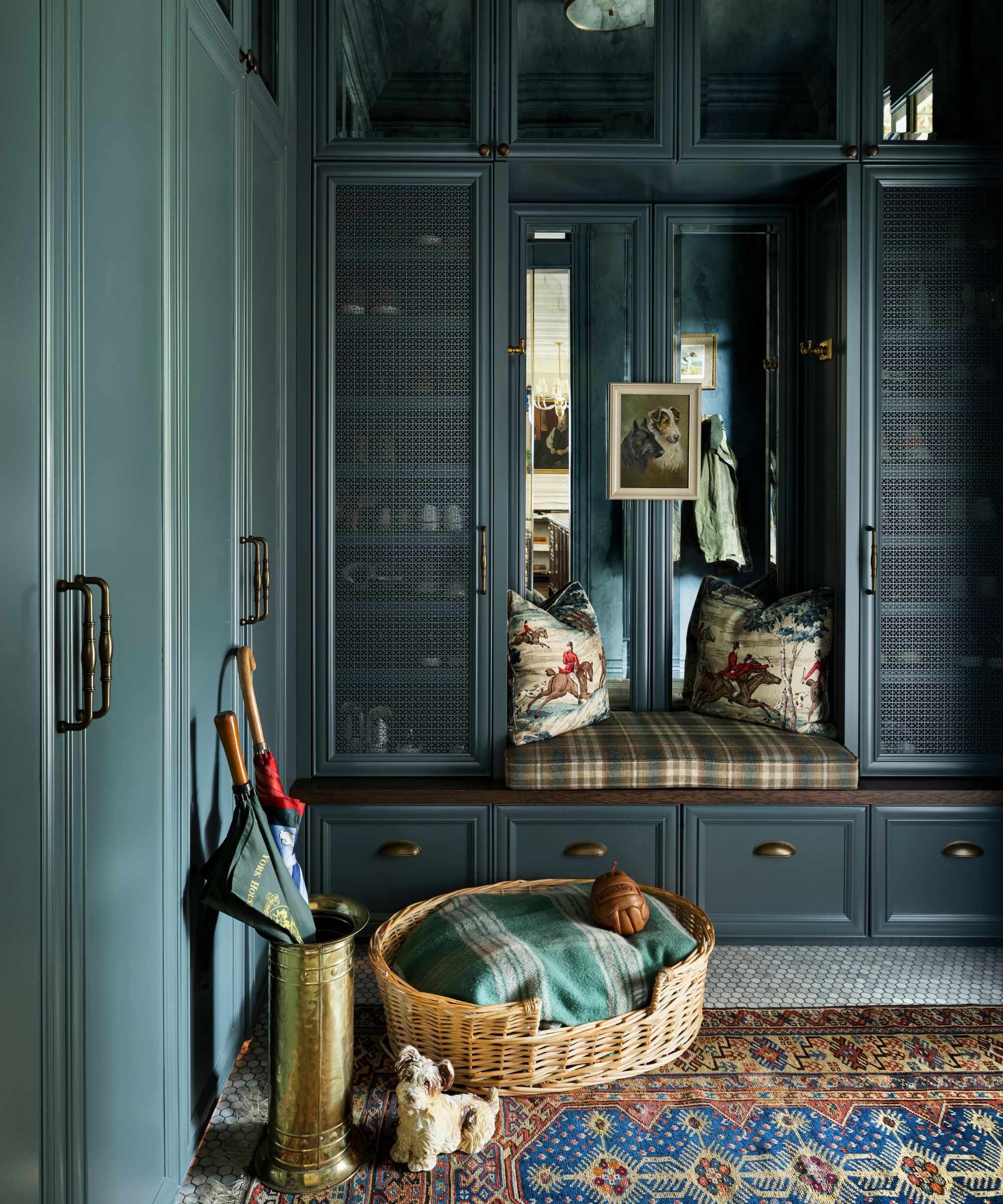 a navy painted boot room with dog bed and dog lead hooks