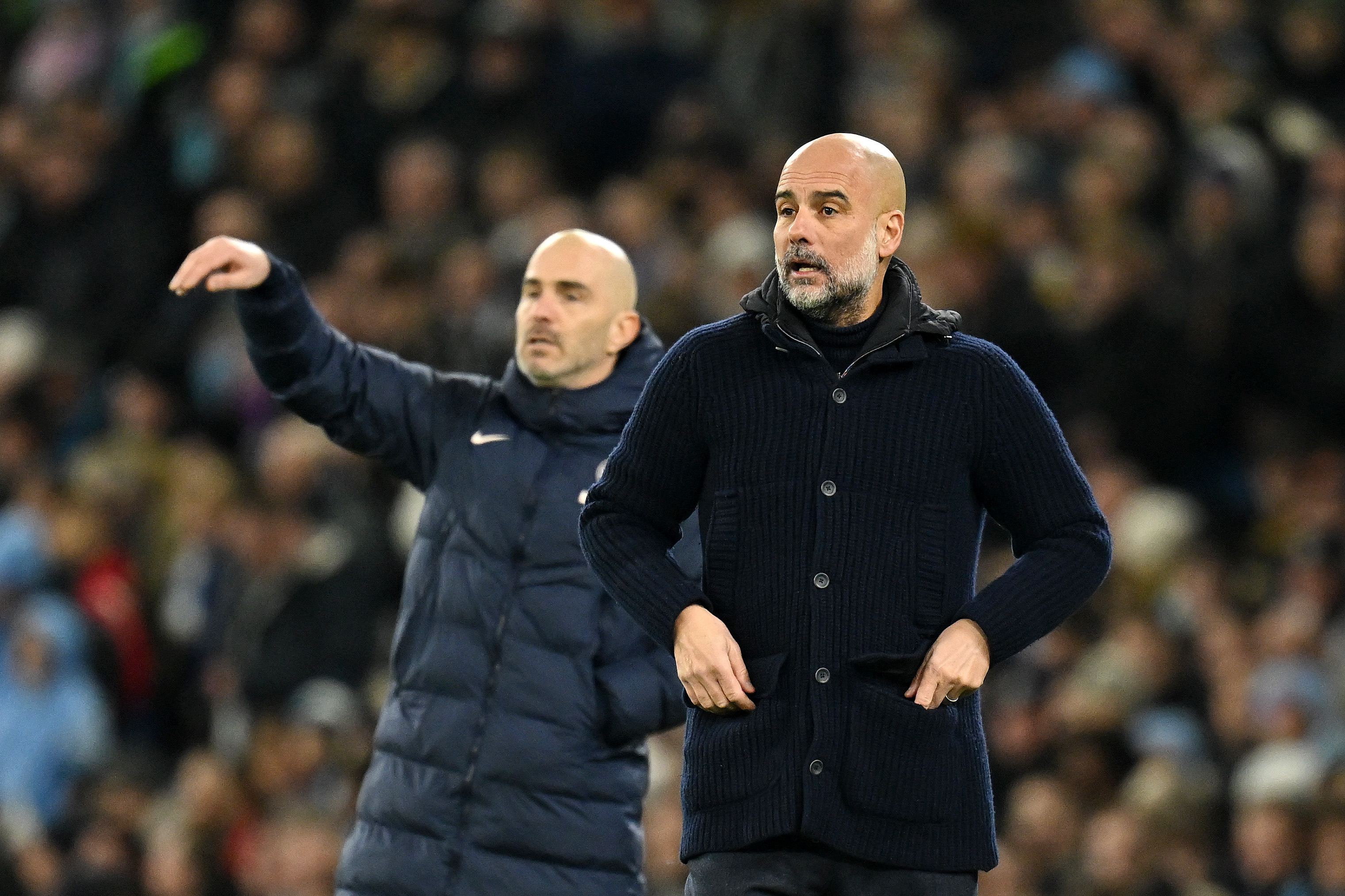 MANCHESTER, ENGLAND - JANUARY 25: Pep Guardiola, Manager of Manchester City, reacts as Enzo Maresca, Manager of Chelsea (obscured), gives the team instructions during the Premier League match between Manchester City FC and Chelsea FC at Etihad Stadium on January 25, 2025 in Manchester, England. (Photo by Michael Regan/Getty Images)
