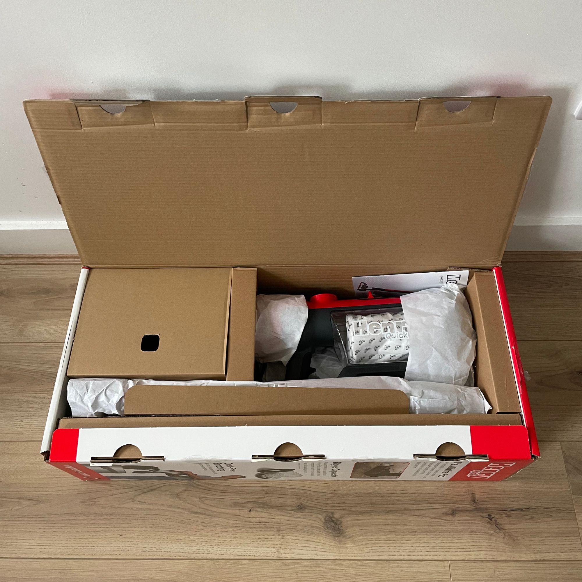 Opened box of the Henry Quick Corded  Vacuum Cleaner, with the contents showing inside