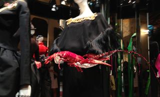 A mannequin holds a jewelled lobster
