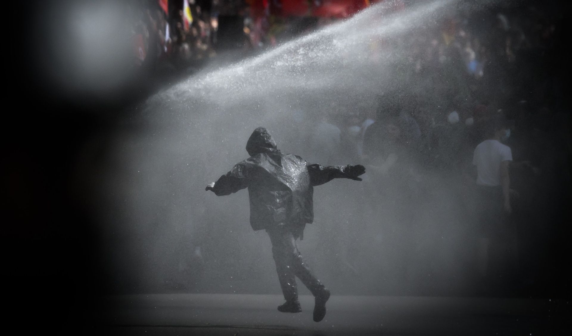 
                                A demonstrator is soaked by a police water cannon during an International Workers&#039; Day rally in Nantes, France
                            