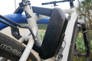 hiplok dx1000 locking up an ebike to a blue bike bike rack