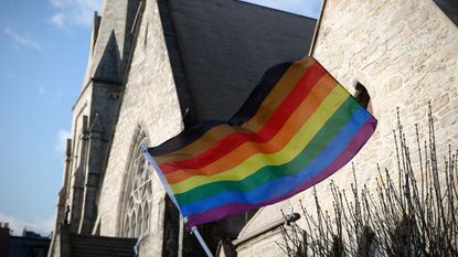 United Methodist Church with LGBTQ+ rainbow flag