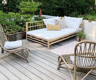 light grey decked patio area with day bed and chairs