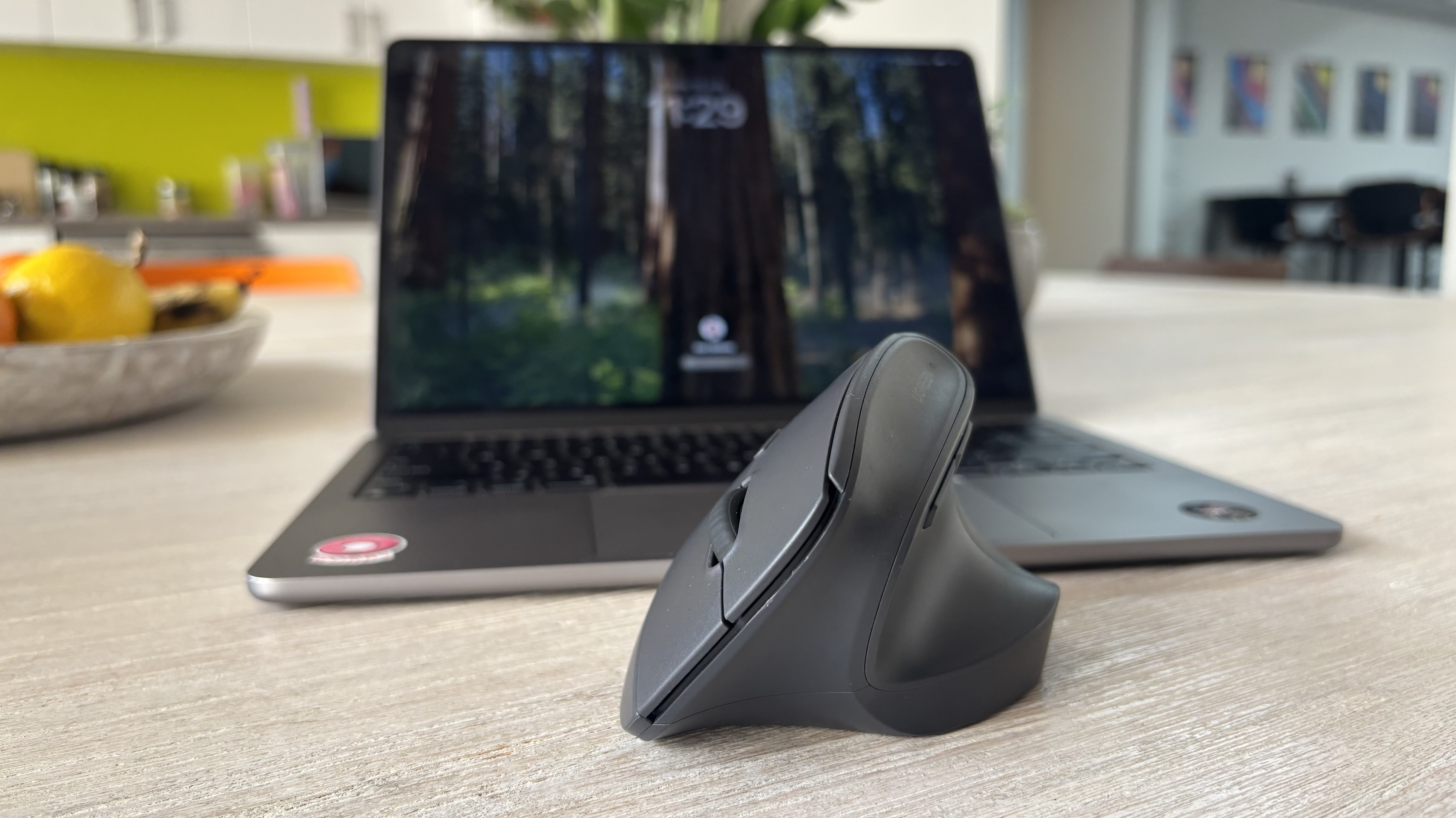 Ugreen M571 vertical mouse in front of a MacBook Air