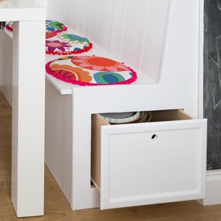 pull out storage built in to white kitchen booth