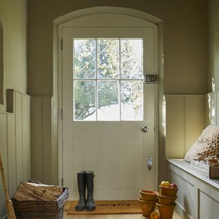 white door with door mat and black shoes