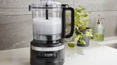 How to clean a food processor: A KitchenAid food chopper filled with water and bubbles