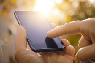 A mobile phone in somebody&amp;#039;s hand