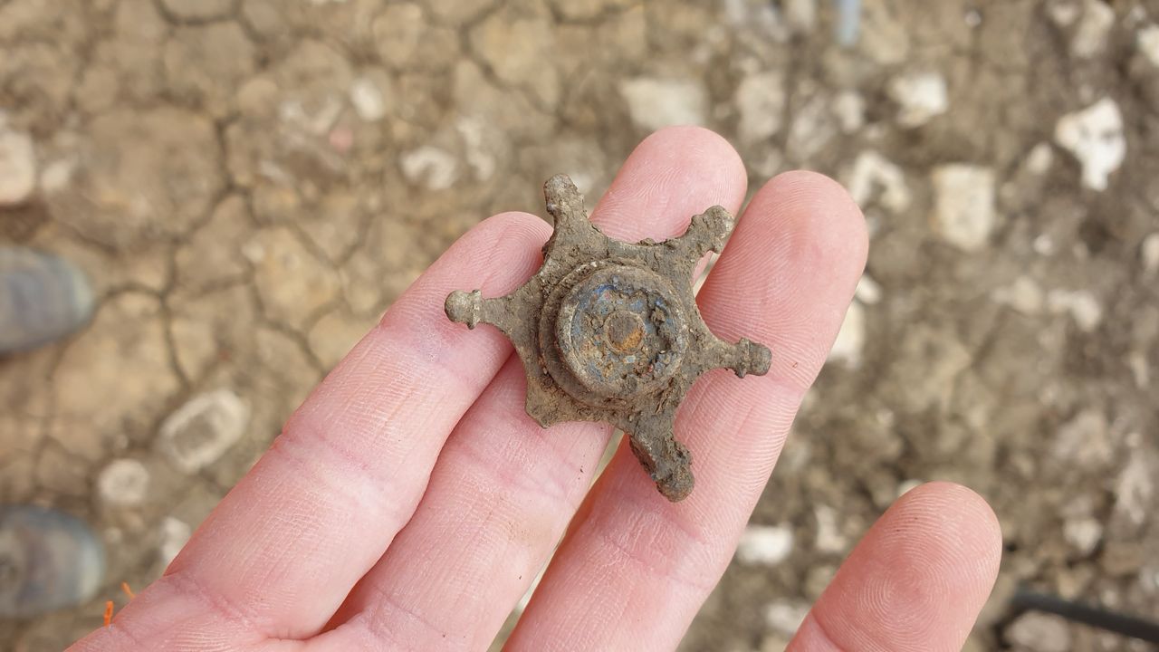 A metal broach uncovered at the site.