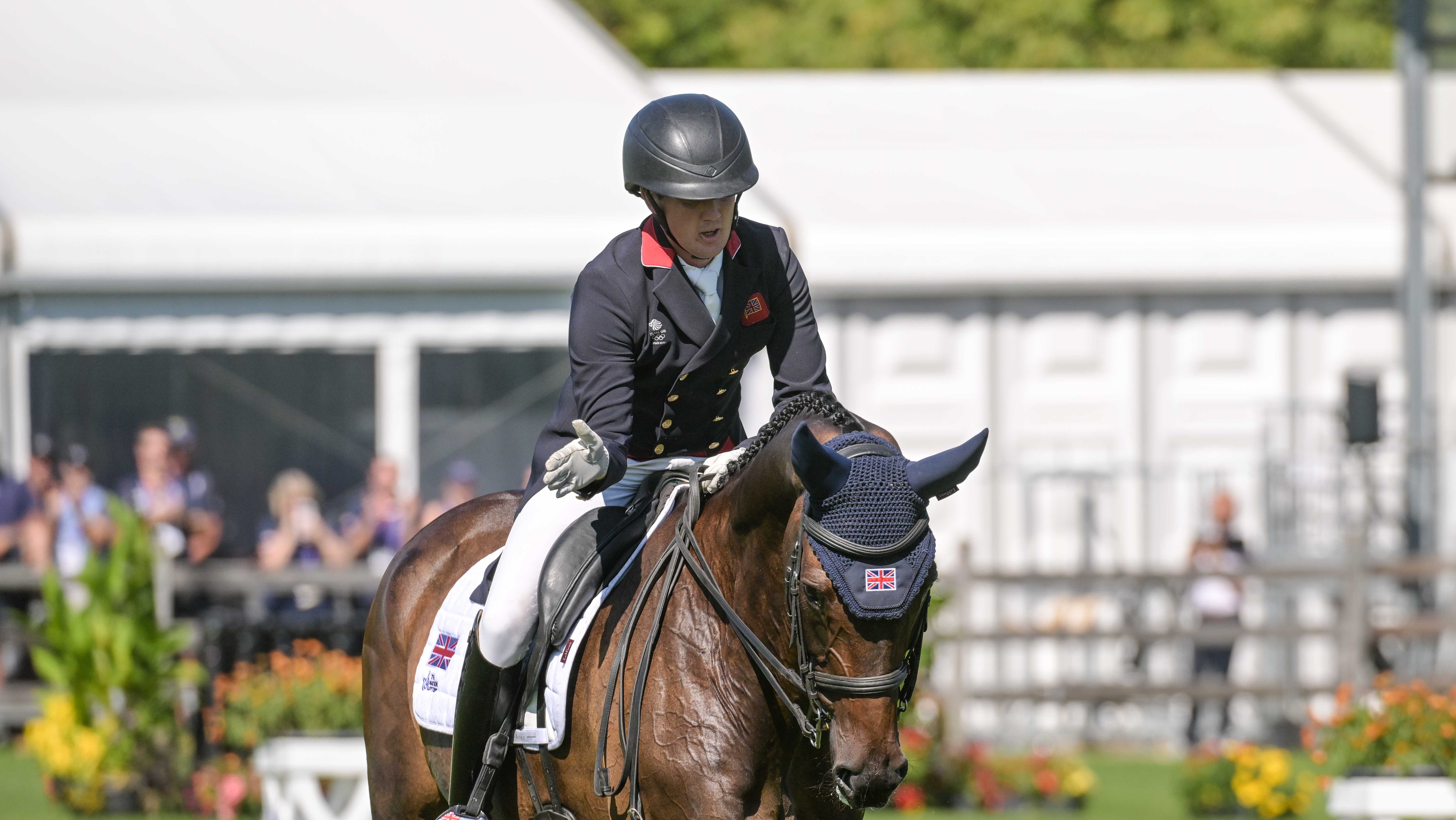 Tom McEwen pats JL Dublin after their dressage test at the eventing World Championships