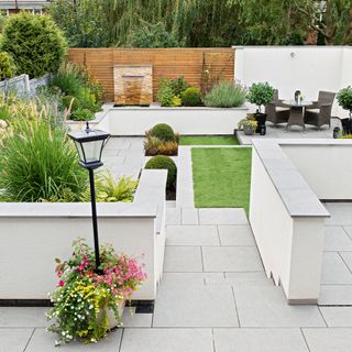 paved outdoor area with white walls