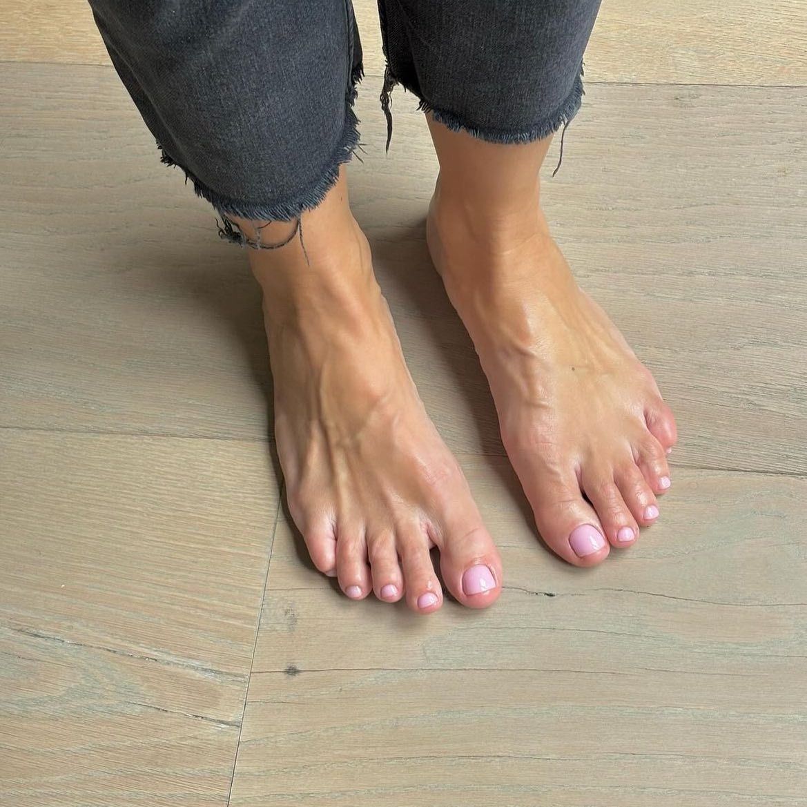 A photo of feet with a baby pink pedicure colour