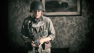 Kate Winslet in army gear with a Rolleiflex camera as Lee Miller in Lee