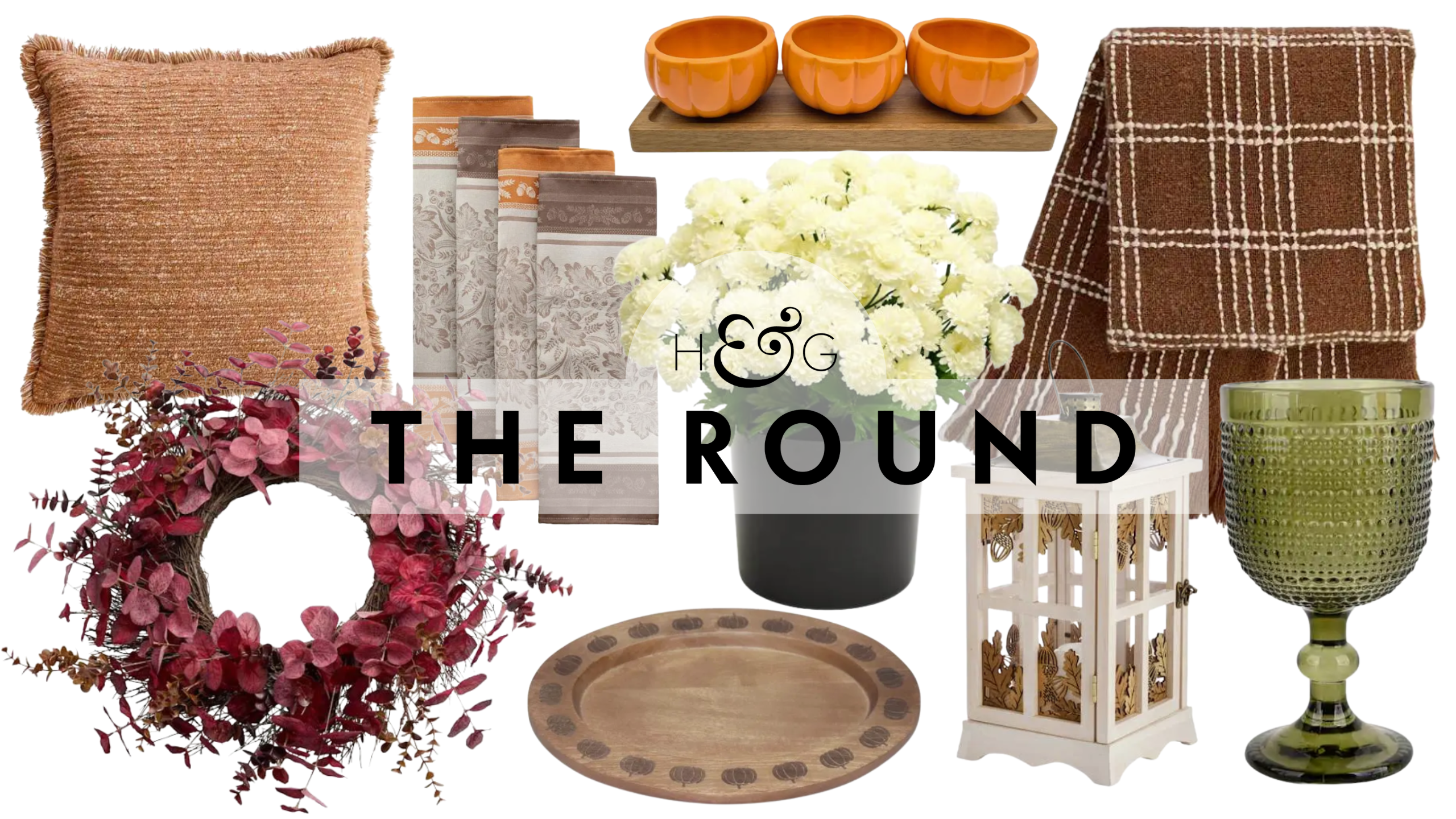 At Home fall decor for 2026, including a textured throw pillow, eucalyptus wreath, napkins, serving platter, floral arrangement, pumpkin snack server, lantern, throw blanket, and green glass goblet.