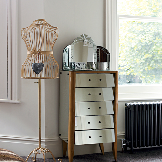 room with white wall and drawer units and cloth stand