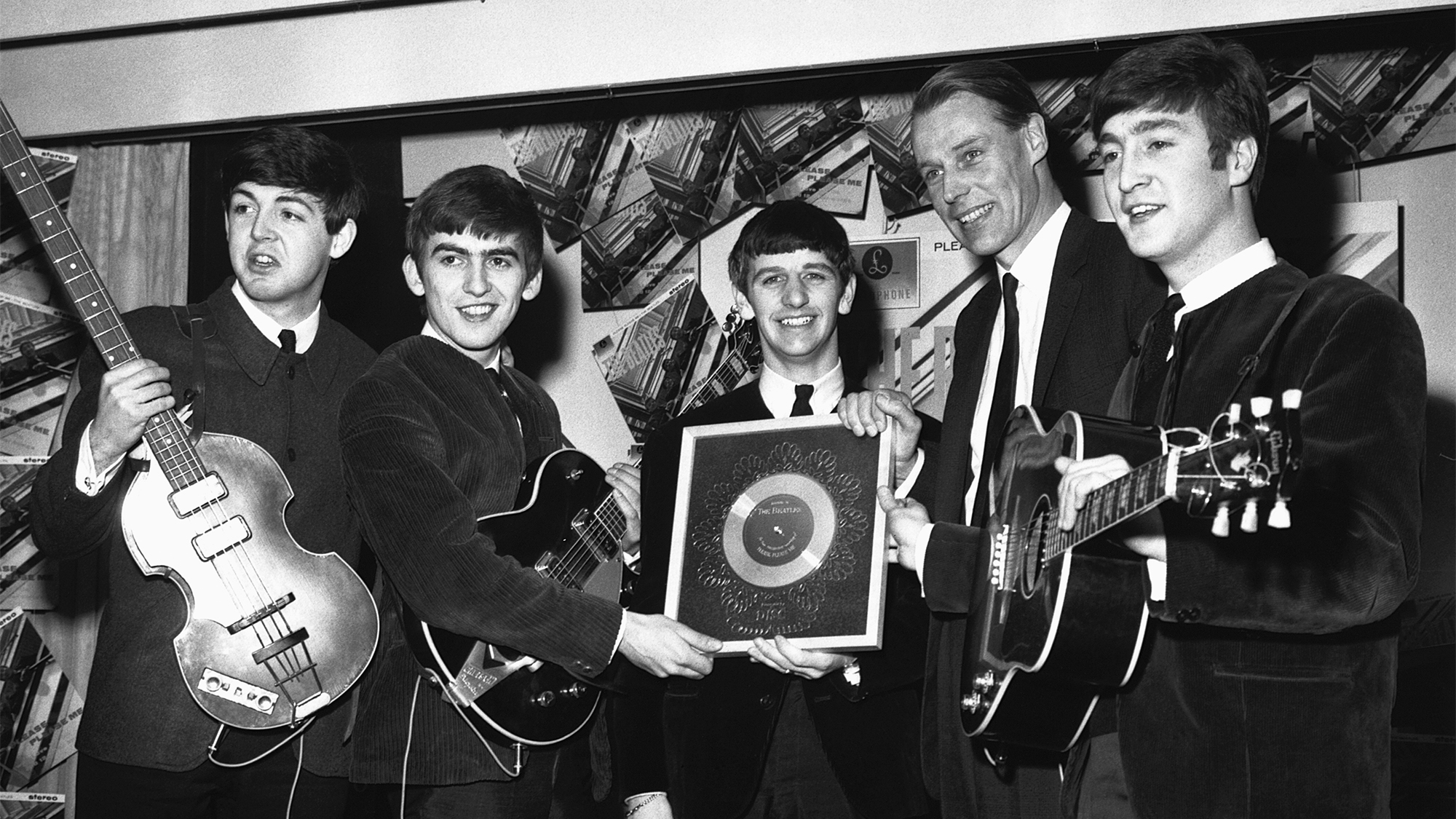 The Beatles and George Martin with the silver disc which they have been awarded after selling 1/4 million copies of their hit single Please Please Me.