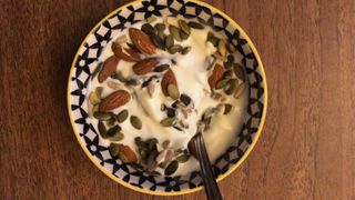 A bowl of yoghurt with almond and seeds