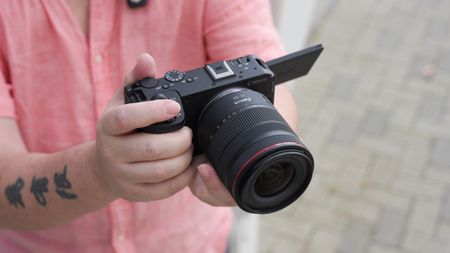 Canon EOS R6 V with the Canon RF 20-50mm f/4L IS USM PZ being held outdoors