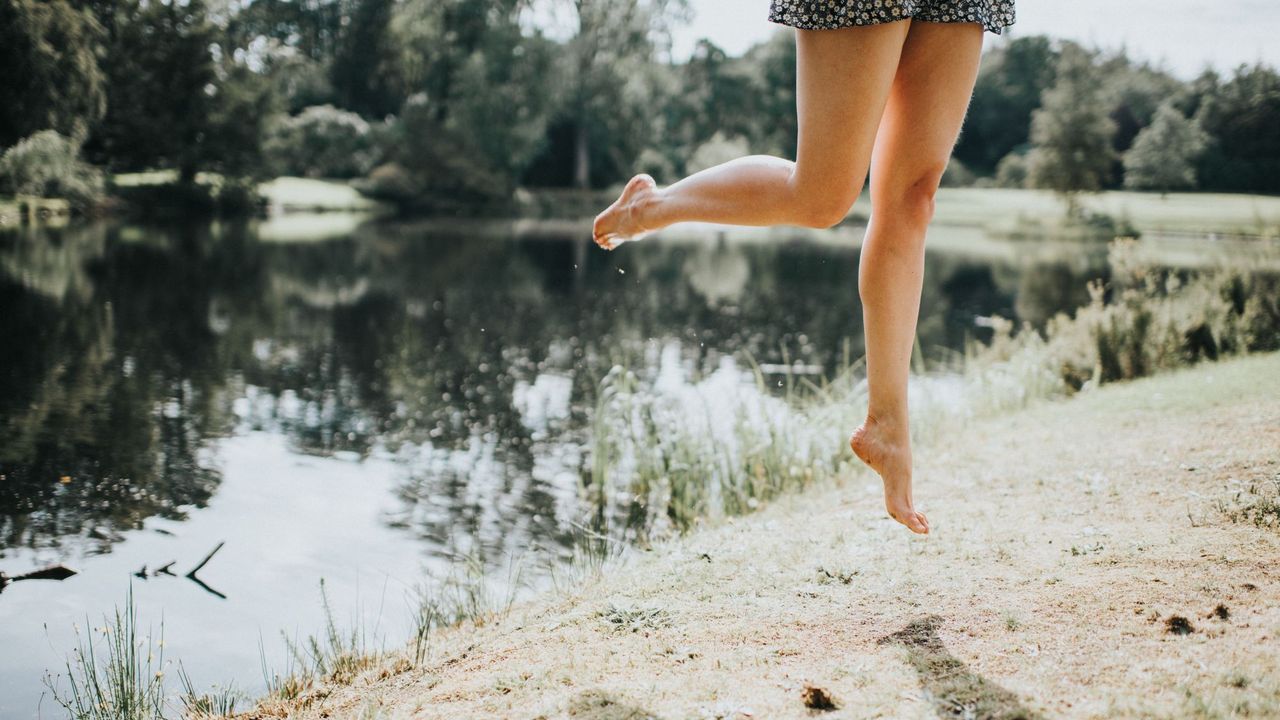 CurrentBody Laser Hair Removal Device - woman jumping in field getty images 1169993276