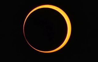 an orange ring of light against a black background.