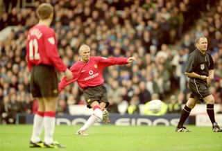 David Beckham scores a free-kick for Manchester United against rivals Manchester City at Maine Road in 2000.